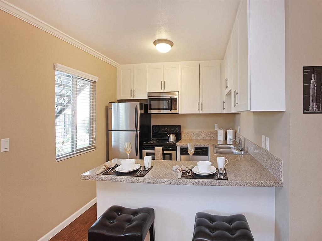 a kitchen with a counter top and a refrigerator