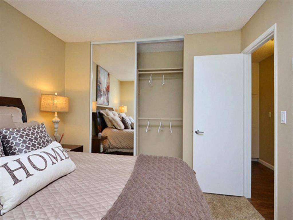 a bedroom with a bed and a closet