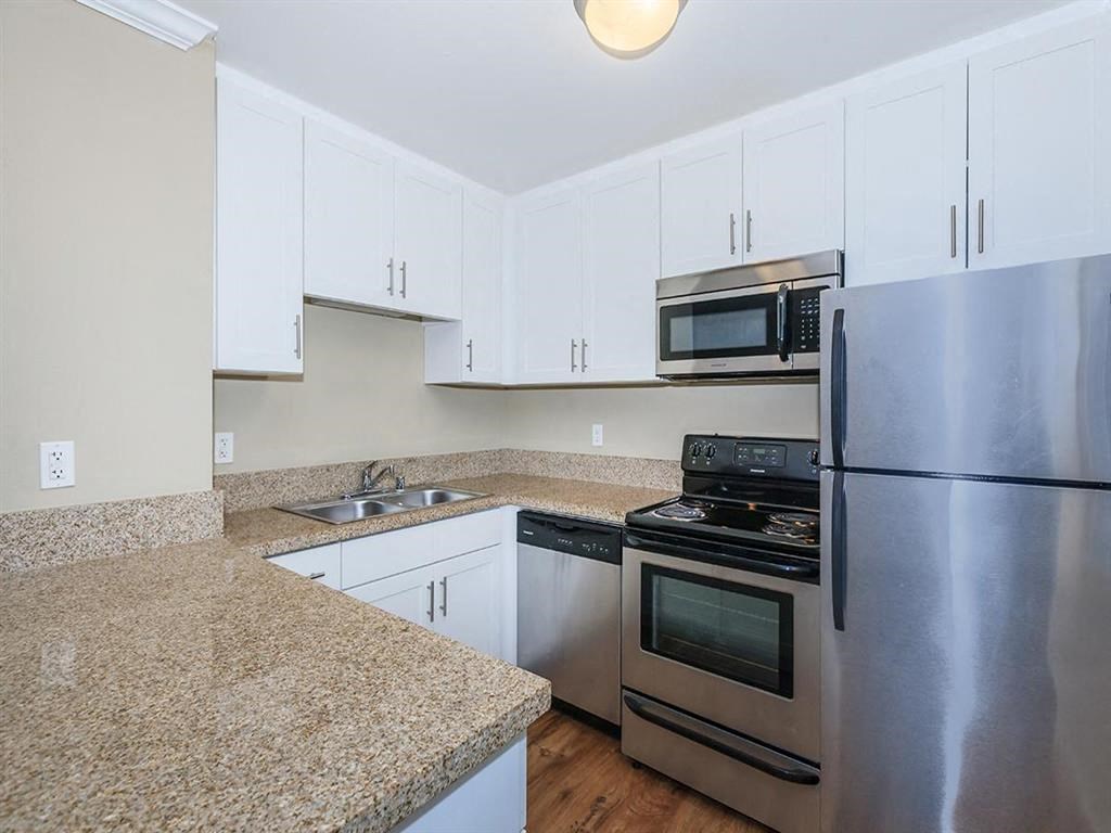 a kitchen with granite counter tops and stainless steel appliances