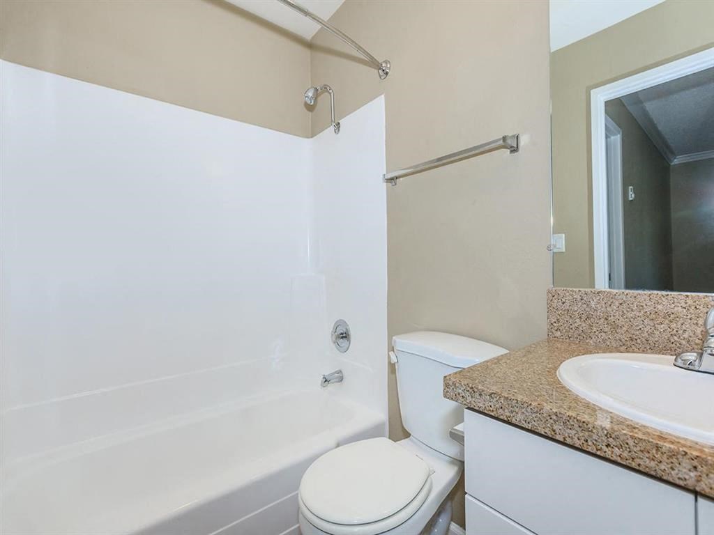 a bathroom with a shower toilet and sink