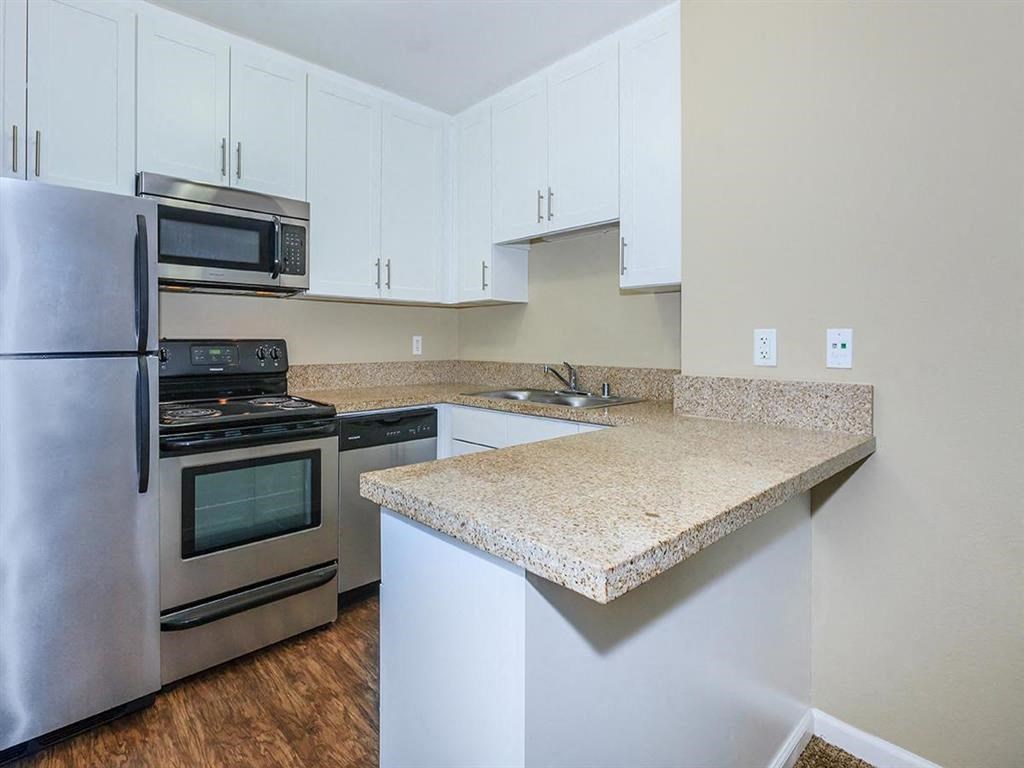 a kitchen with granite counter top and stainless steel appliances