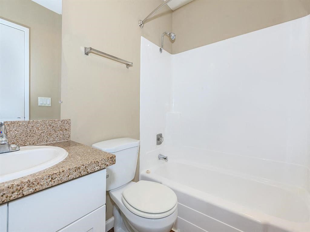 a bathroom with a sink toilet and a bath tub