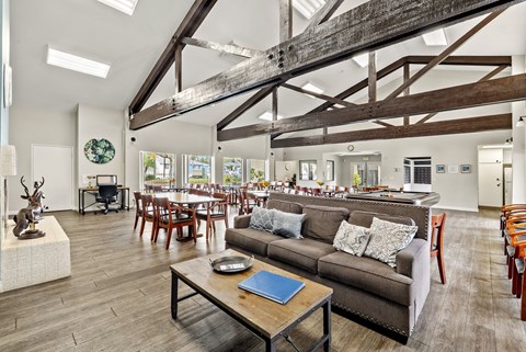 A living room with a brown couch and a wooden coffee table.