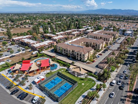 A large building complex with a pool in the foreground.