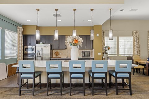 A kitchen with a table and chairs in the foreground.