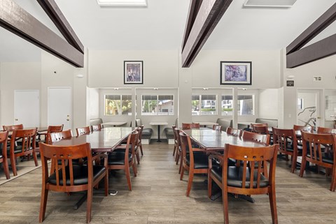 A dining room with a long table and chairs.