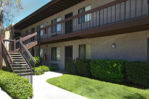 A building with a balcony and stairs leading to it.