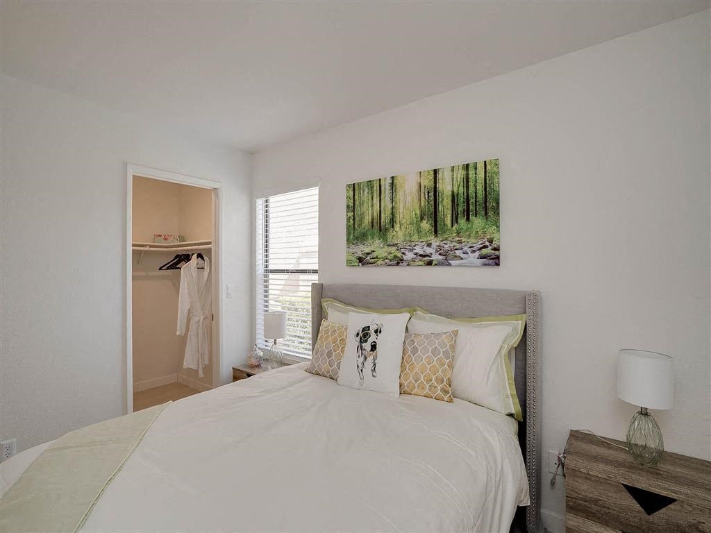 a bedroom with a bed and a closet