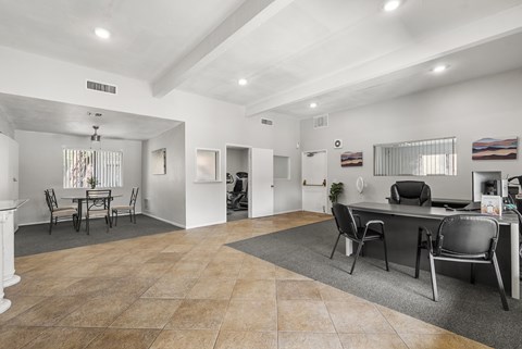 A spacious room with a dining table and chairs.