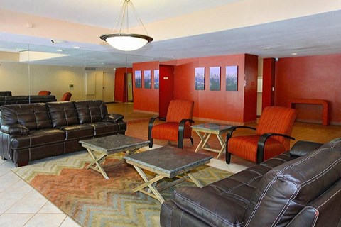 a living room with leather couches and chairs
