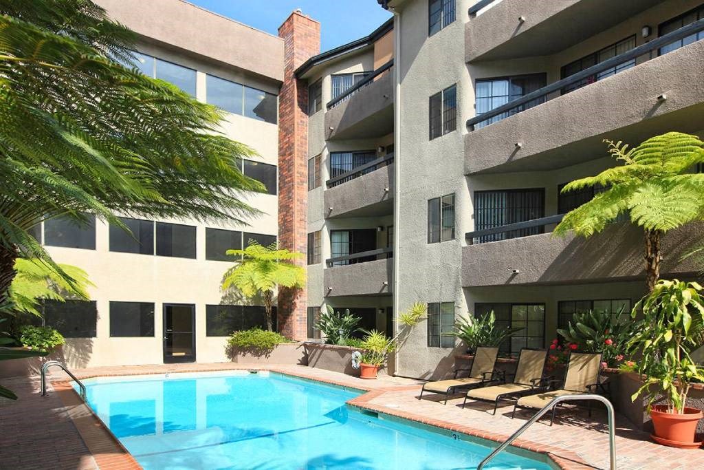 a swimming pool in front of an apartment building