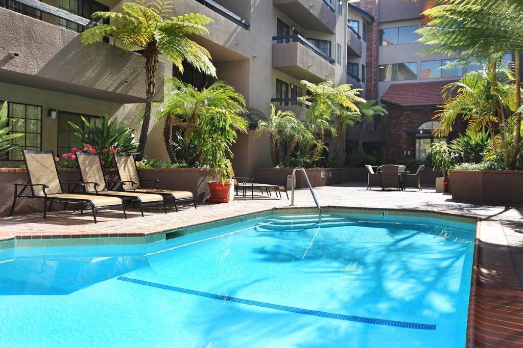 a swimming pool in front of an apartment building