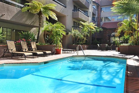 a swimming pool in front of an apartment building