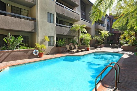 a large swimming pool in front of a building