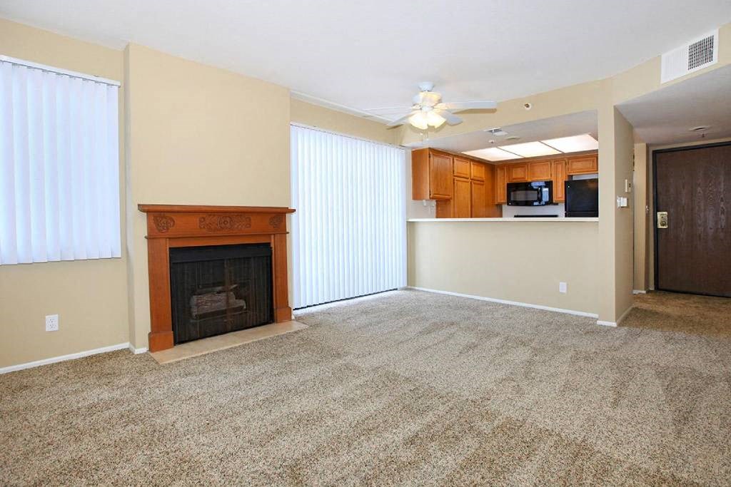 an empty living room with a fireplace