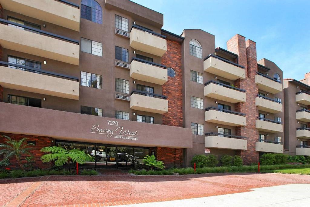 an apartment building with a brick facade and a sign that reads the sugar loft