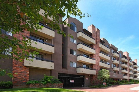 an apartment building with many balconies and a black gate