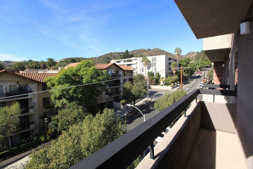 a view of the street from the balcony of a condo