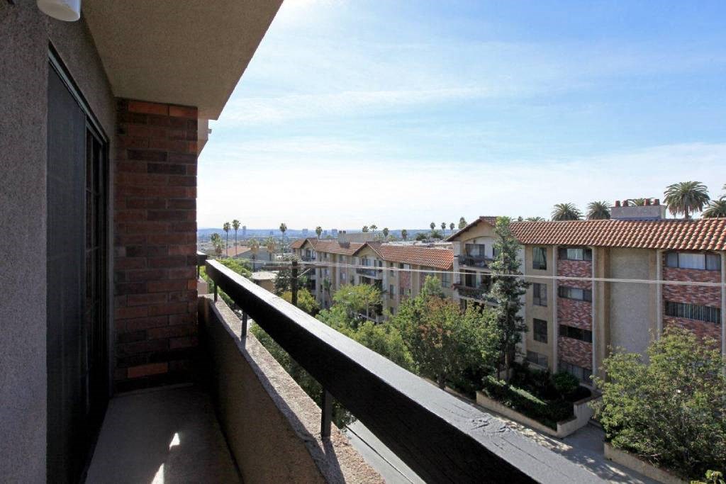 a view of the city from the balcony of a condo