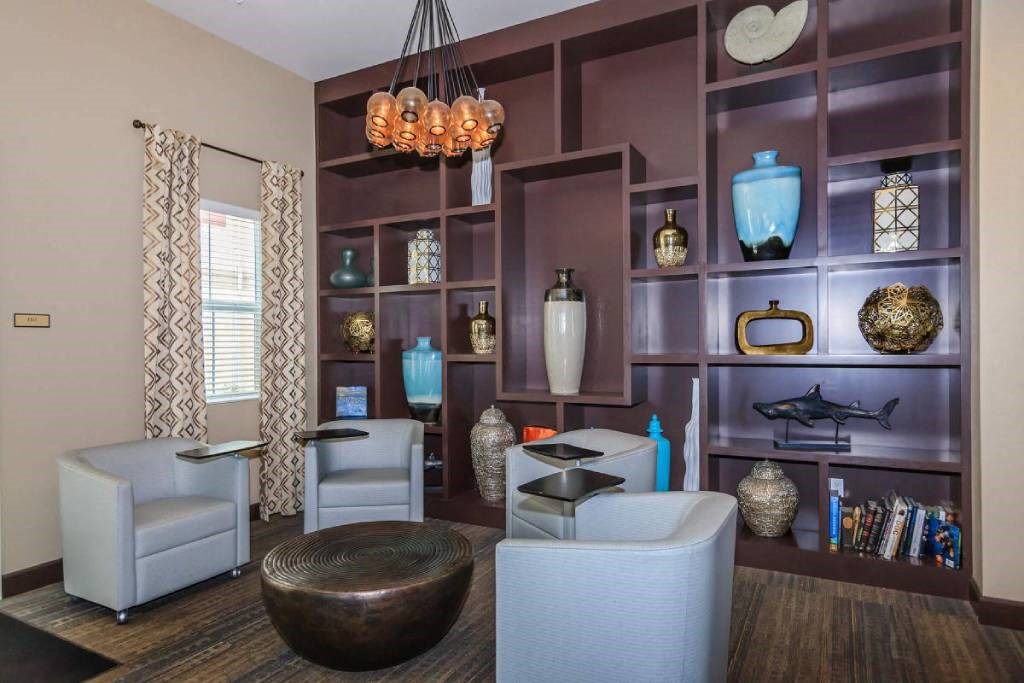 a living room with chairs and a wall with vases