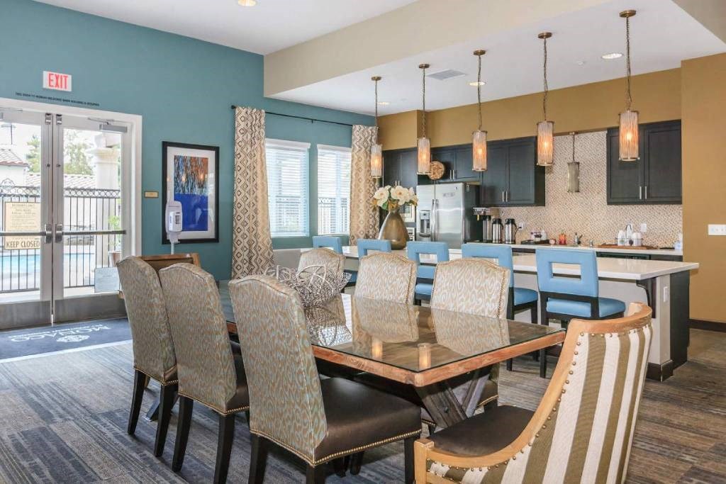 a dining room and kitchen with a table and chairs
