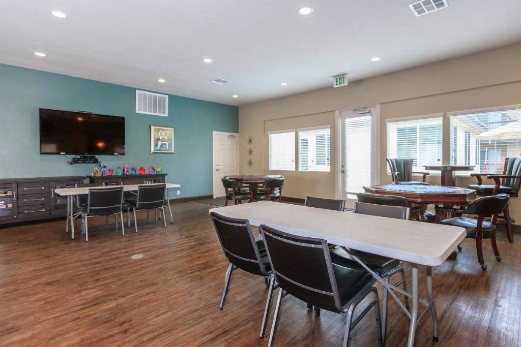 a dining room with a table and chairs and a tv