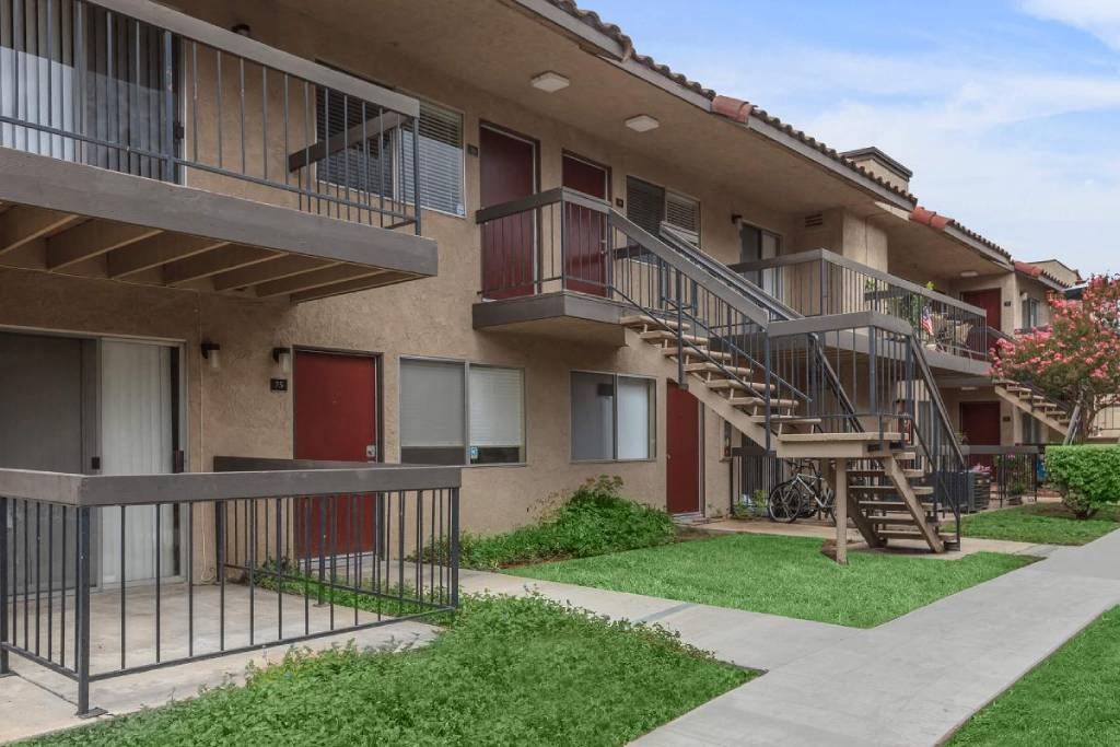 an exterior view of an apartment building with stairs