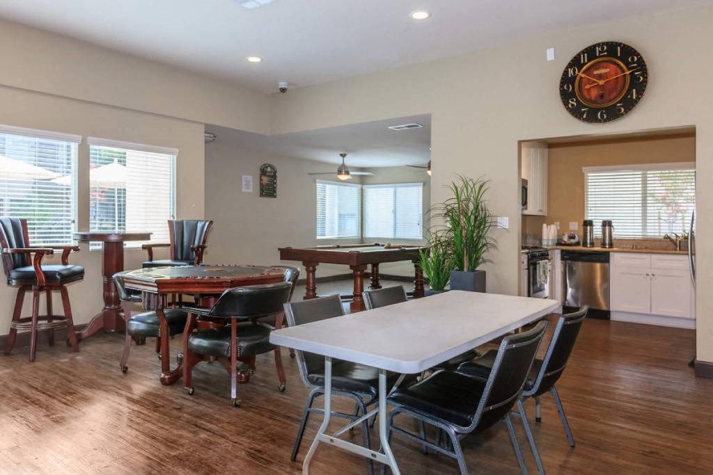 a dining room with a table and chairs and a pool table