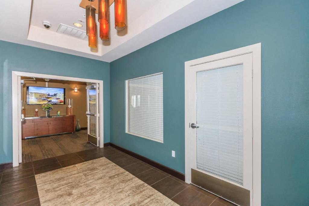 a blue walled room with a door and a mirror