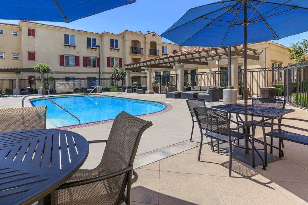 our apartments have a pool and tables and umbrellas