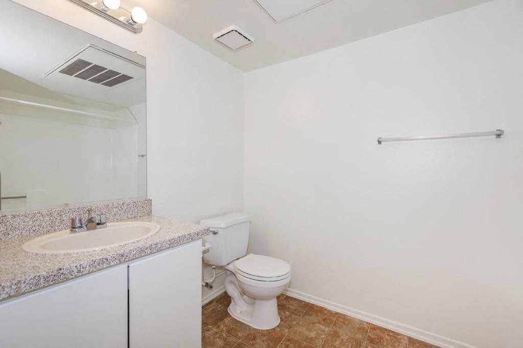 a bathroom with a sink toilet and a mirror