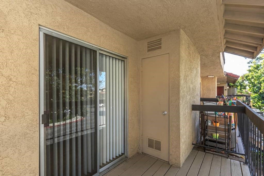 a patio with a door and a balcony