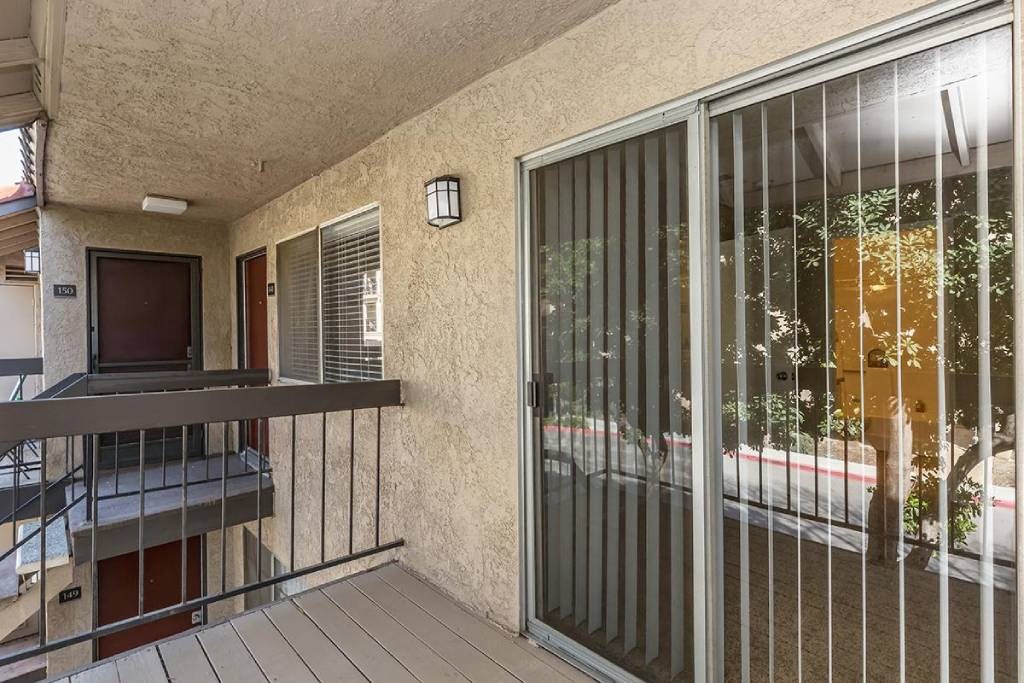 a view of a balcony with a sliding glass door