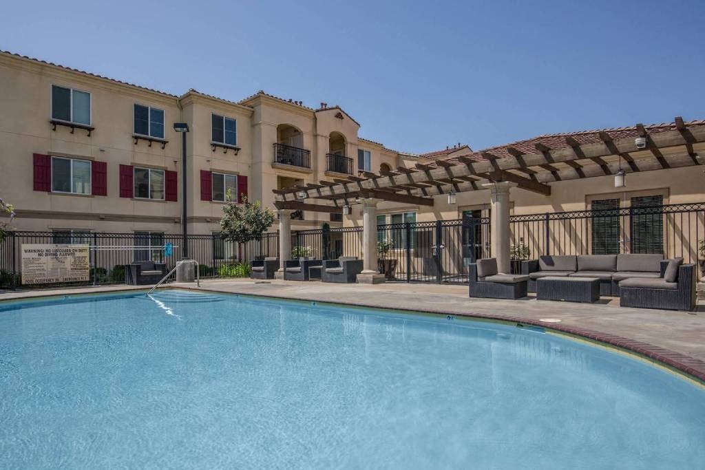 a large swimming pool in front of a building
