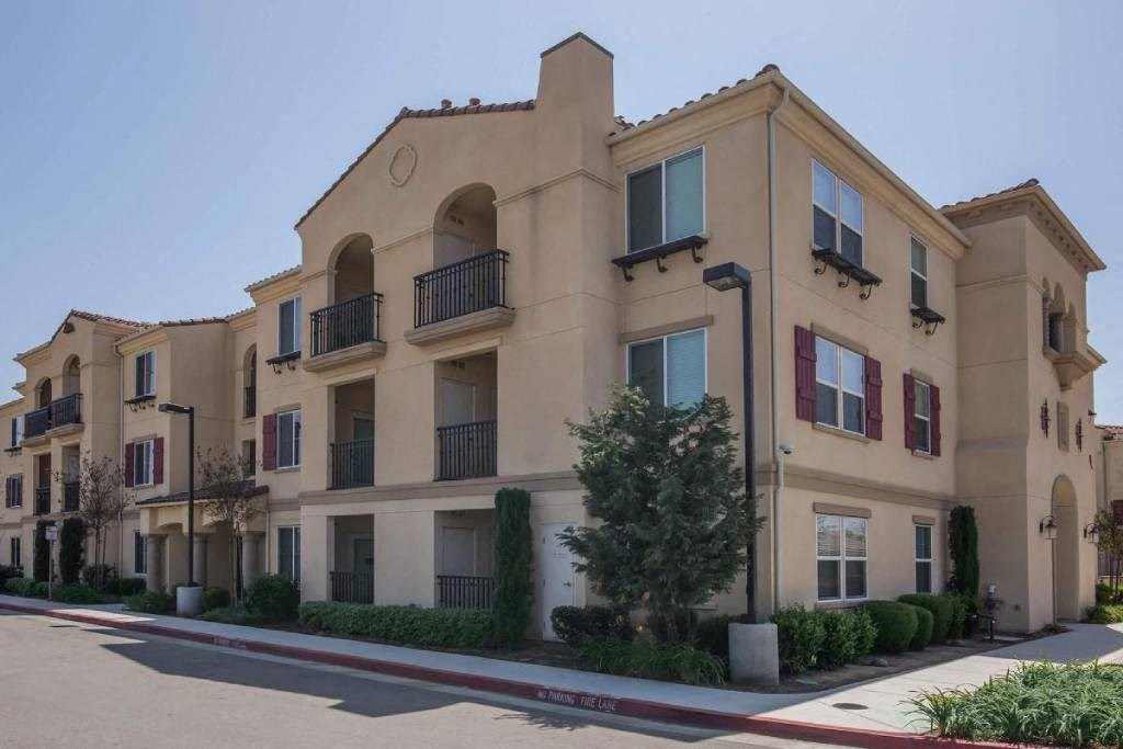 an apartment building on the corner of a street