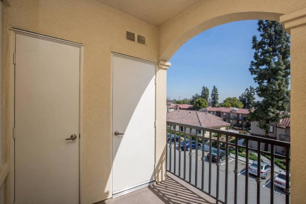 a balcony with a view of a parking lot