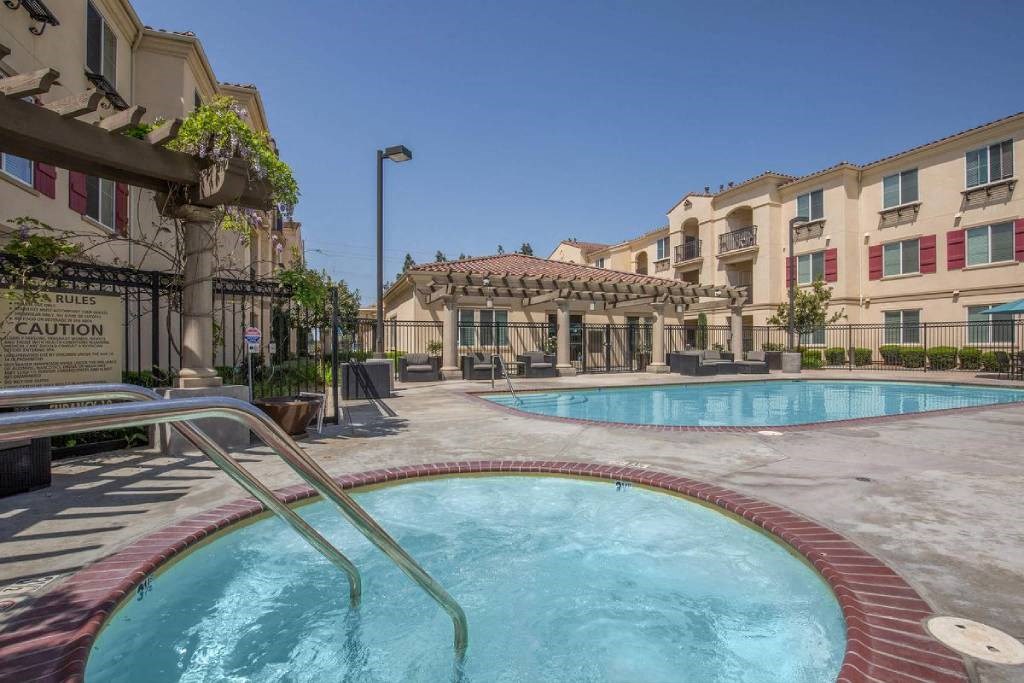 a swimming pool with buildings in the background