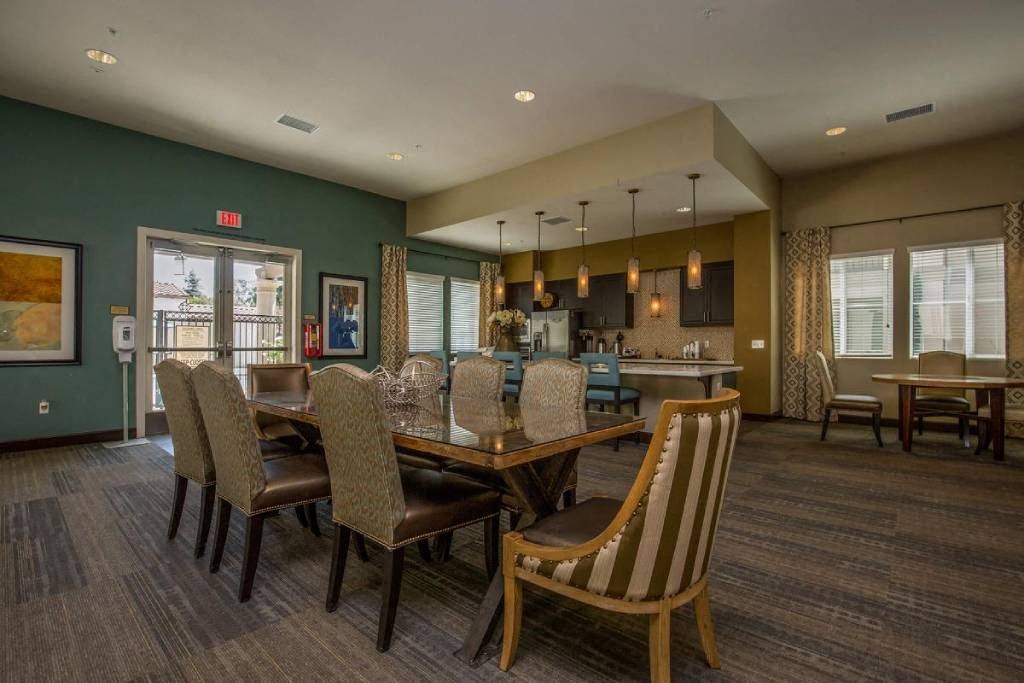 a large dining room with a table and chairs