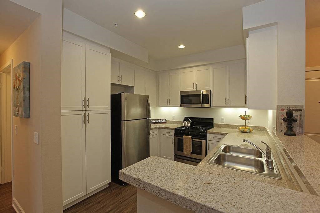 a kitchen with a sink and a refrigerator