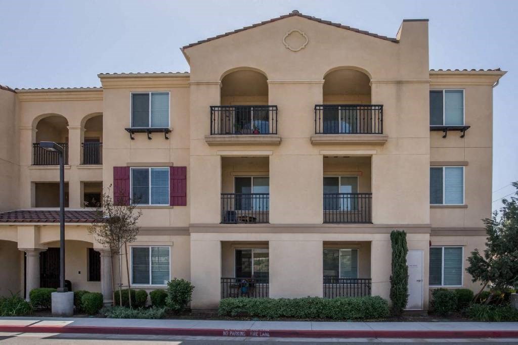 a building with balconies and a street in front of it