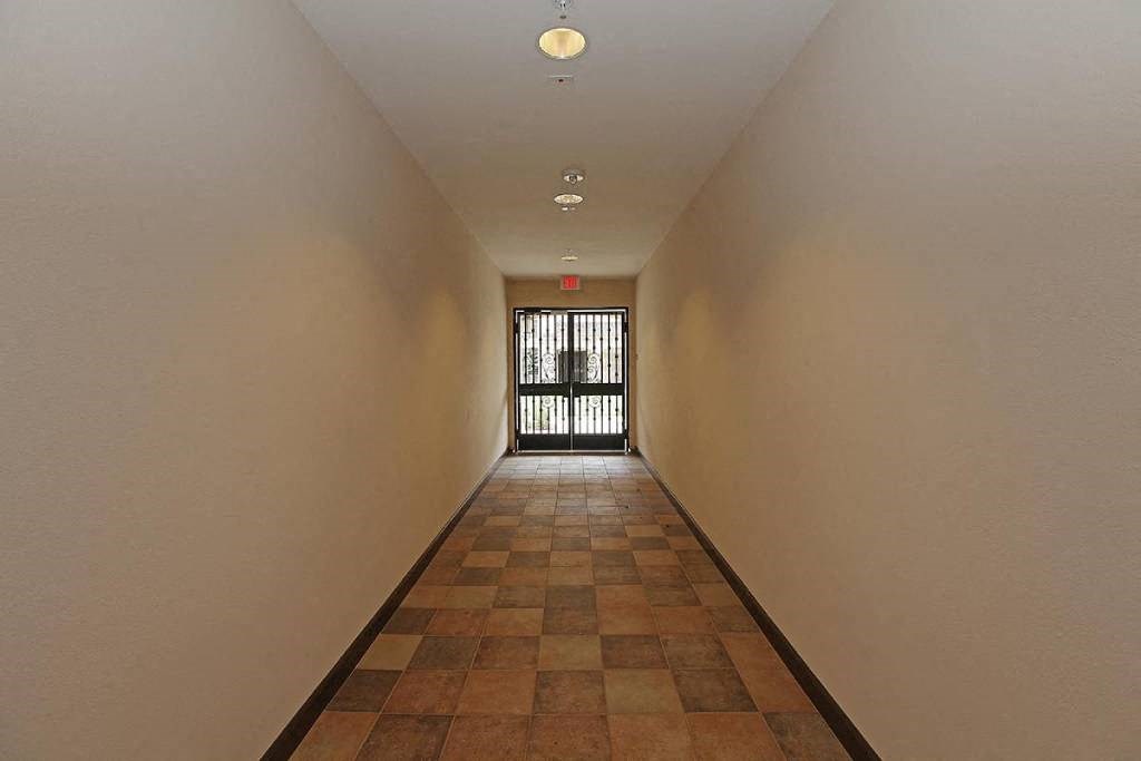 a long hallway with a door at the end of it