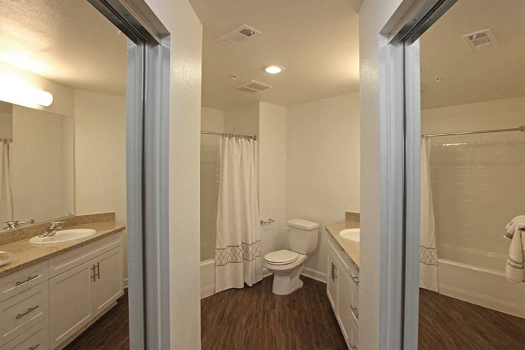 a bathroom with a toilet and a sink and a mirror
