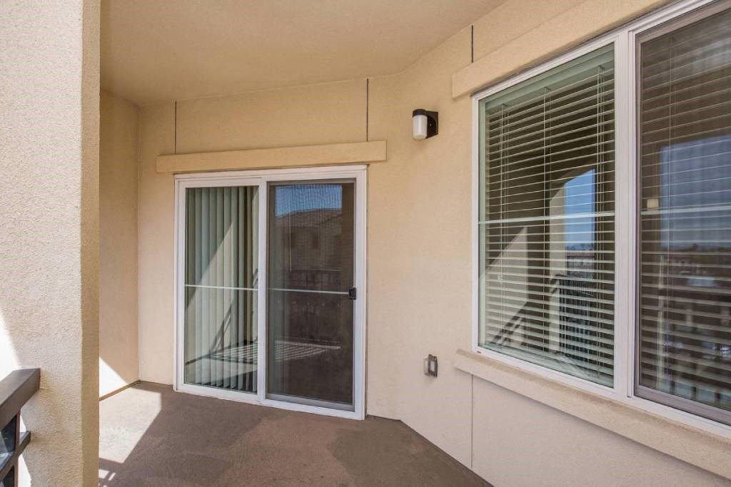 a balcony with a sliding glass door and a window