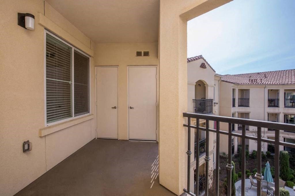 a balcony or terrace with a door and a window