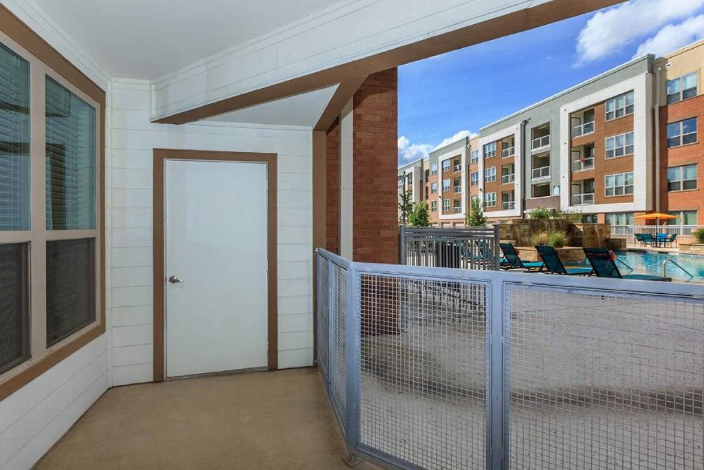 a balcony with a pool and a door to a building