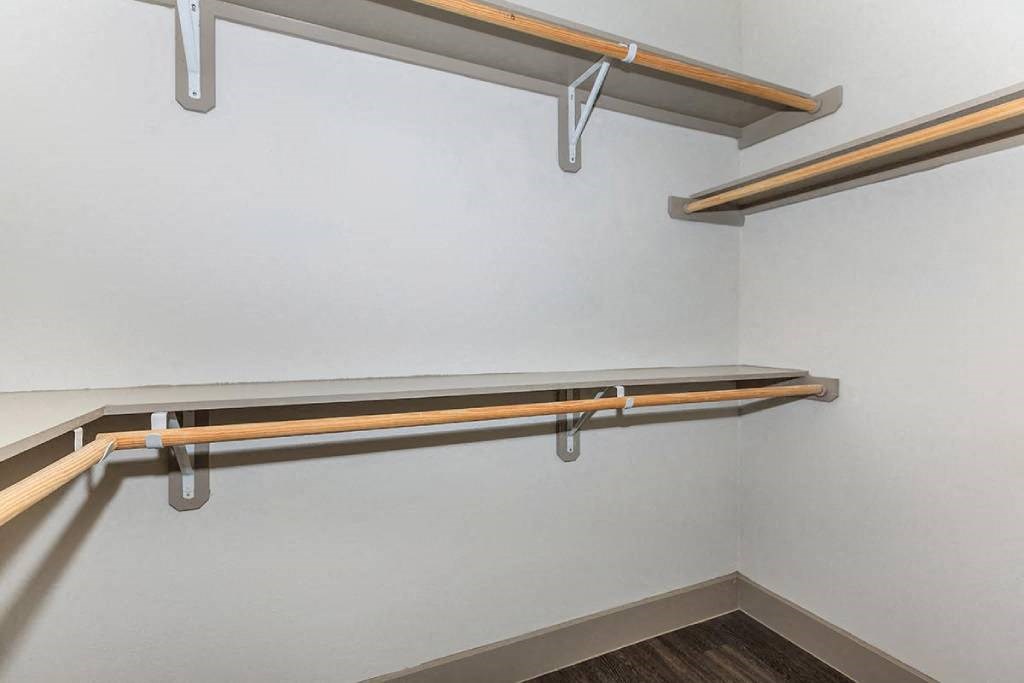 a hanging rail on a wall in a walk in closet