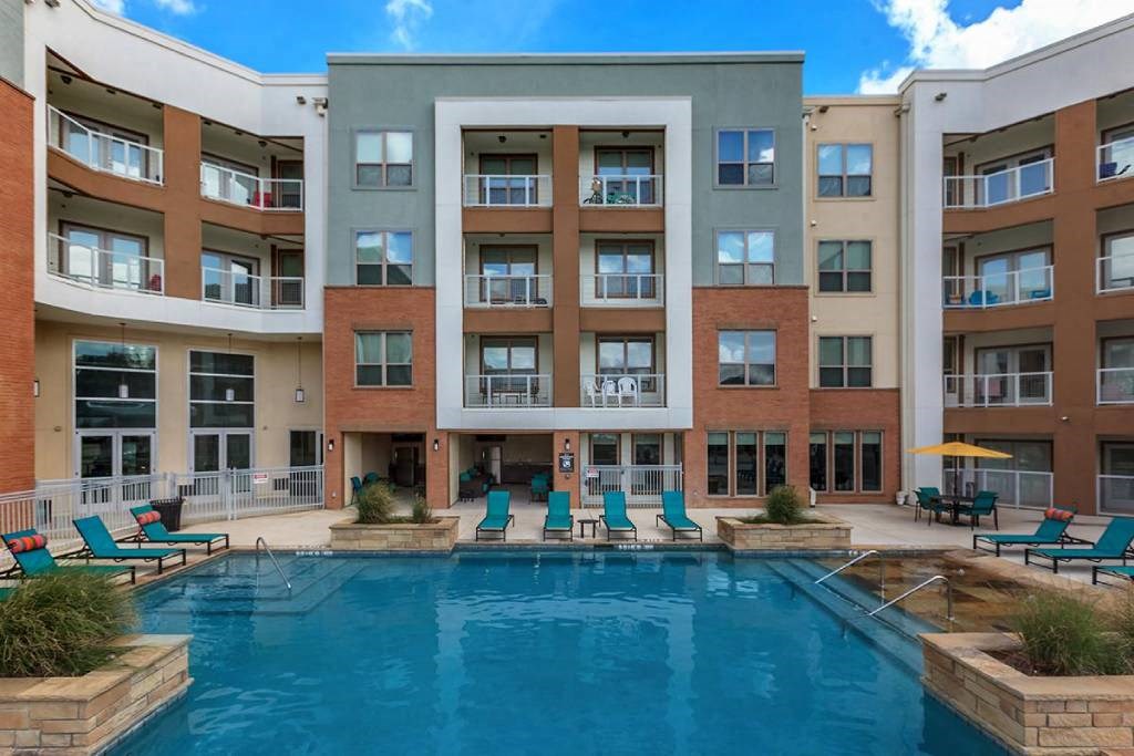 a large swimming pool in front of a building