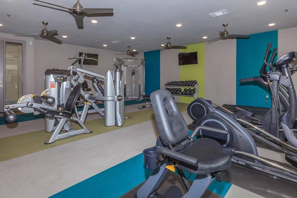 a gym with various machines and weights in a home gym