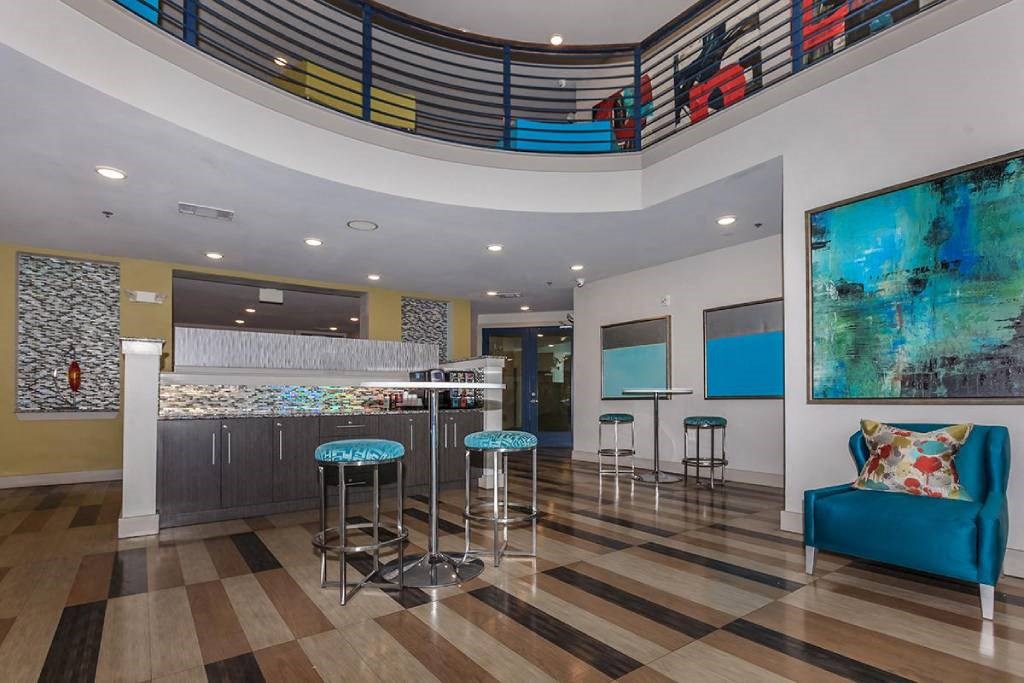 a lobby with a bar and a blue chair