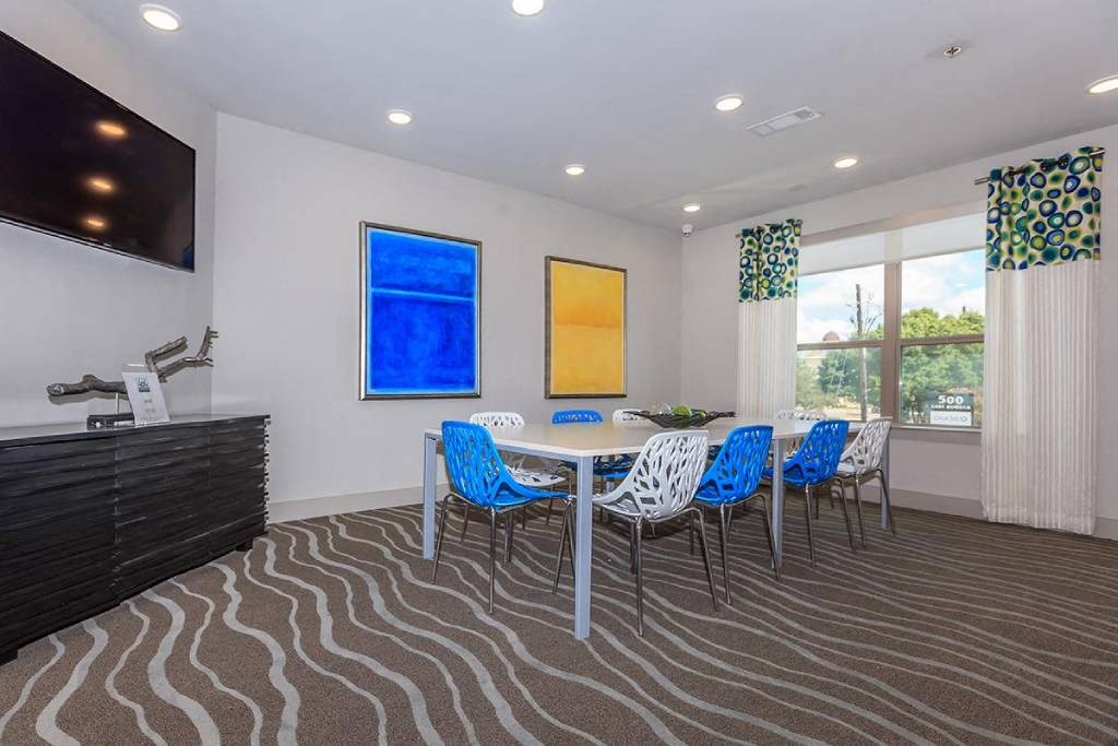 a dining room with a table and chairs